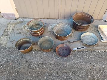 vari recipienti in rame e padelle in ferro