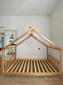Letto Montessori a casetta in legno naturale.