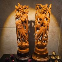 Coppia di sculture Krishna e Saraswati in legno in