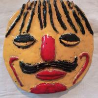 Bassorilievo in terracotta invetriata: viso d'uomo