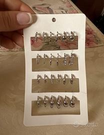 12 paia di orecchini color argento