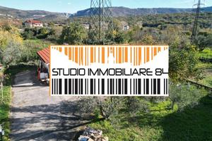 DOMIO: Terreno edificabile con ampio magazzino/dep