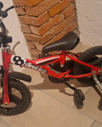 Bicicletta bambino Dinobikes rossa con rotelle