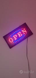 Insegna luminosa Open