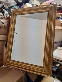 Grande specchio dorato da parete.