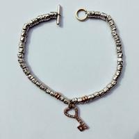 Bracciale DoDo con charm Chiave, Pomellato