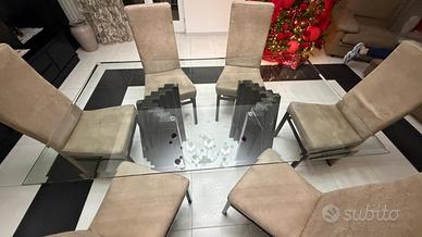 Tavolo da pranzo in vetro con piedi in marmo