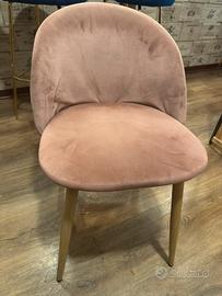 Sedia di velluto rosa con schienale difettoso