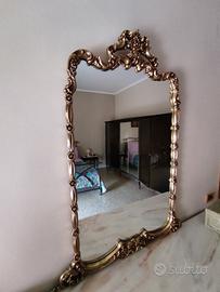 Specchio con cornice dorata.