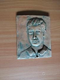 bassorilievo in terra cotta con volto di un uomo 
