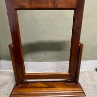 Cornice per specchiera basculante