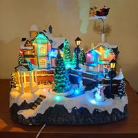 Villaggio natalizio con babbo natale e slitta