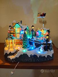 Villaggio natalizio con babbo natale e slitta