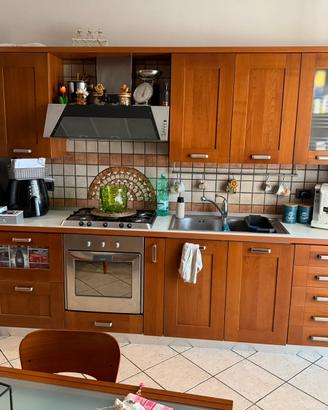 Cucina completa in legno con forno e piano cottura