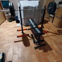 Panca con bilanciere e pesi