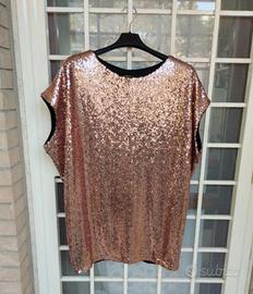 Blusa con paillettes rosa antico.