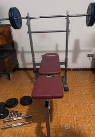 Panca piana con bilanciere e pesi 