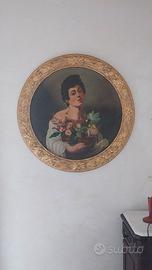 Quadro ovale con cornice dorata