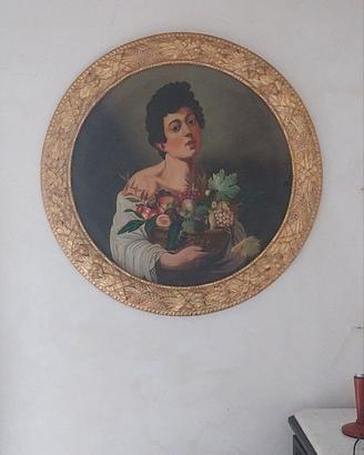 Quadro ovale con cornice dorata