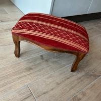 Poggiapiedi vintage in legno con seduta imbottita.