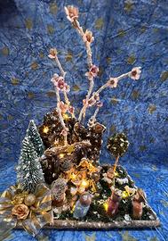 Presepe natalizio con luci e rami di pesco