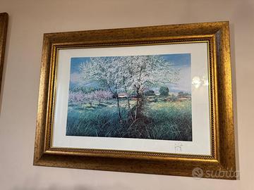 Quadro con paesaggio fiorito e cornice dorata