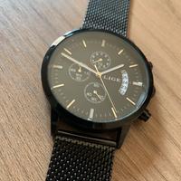 Orologio nero in maglia milanese