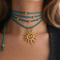 Choker scamosciato verde acqua  con ciondolo sole