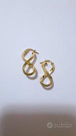 Orecchini infinito con numeri romani oro 18kt 750