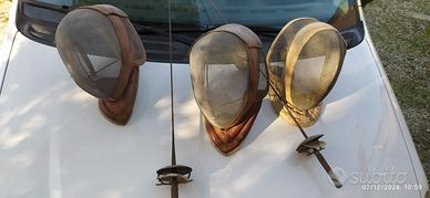 tre antiche maschere da scherma e due fioretti