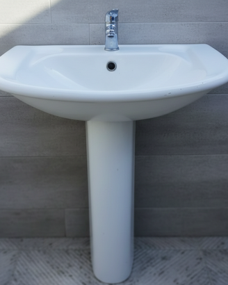 Lavabo con colonna e rubinetto.