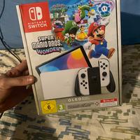 nintedo switch oled più gioche e controller