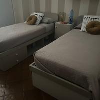 coppia di letti singoli con libreria e cassetti