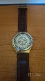 Swatch dorato con cinturino in pelle