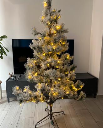Albero innevato con luci