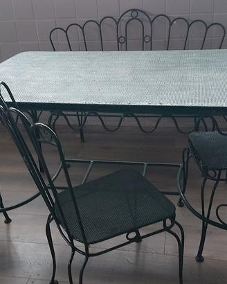 Tavolo da giardino con sedie, panca e carrello.