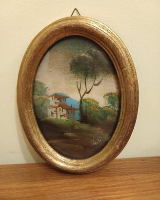 Dipinto paesaggistico con cornice ovale dorata
