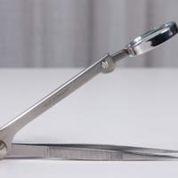 Pinzette pubblicitarie con lente Prasterol