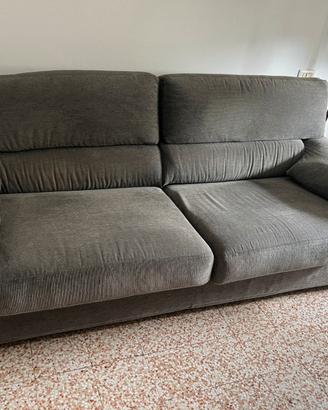 Comodo divano in velluto grigio a costine.