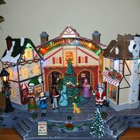 Villaggio natalizio con coro in movimento 