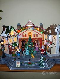 Villaggio natalizio con coro in movimento 