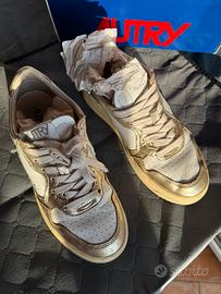 Scarpe in pelle bianca e oro metalizzato Autry