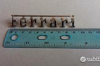 Scritta originale FERRARI in metallo cromato