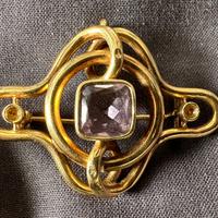 Spilla a nodo in oro, con ametista