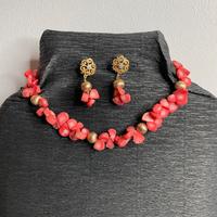 Set di gioielli con pietre rosse e dettagli dorati