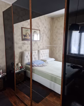 Armadio con ante a specchio e profili in legno