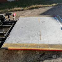 Sponda caricatrice idraulica a battente