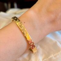 Bracciale monogramma da donna in metallo color oro