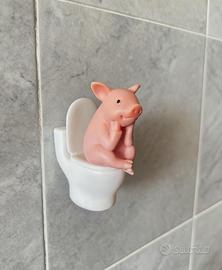 Pig sitting on the toilet