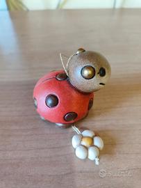 Coccinella Thun con fiore